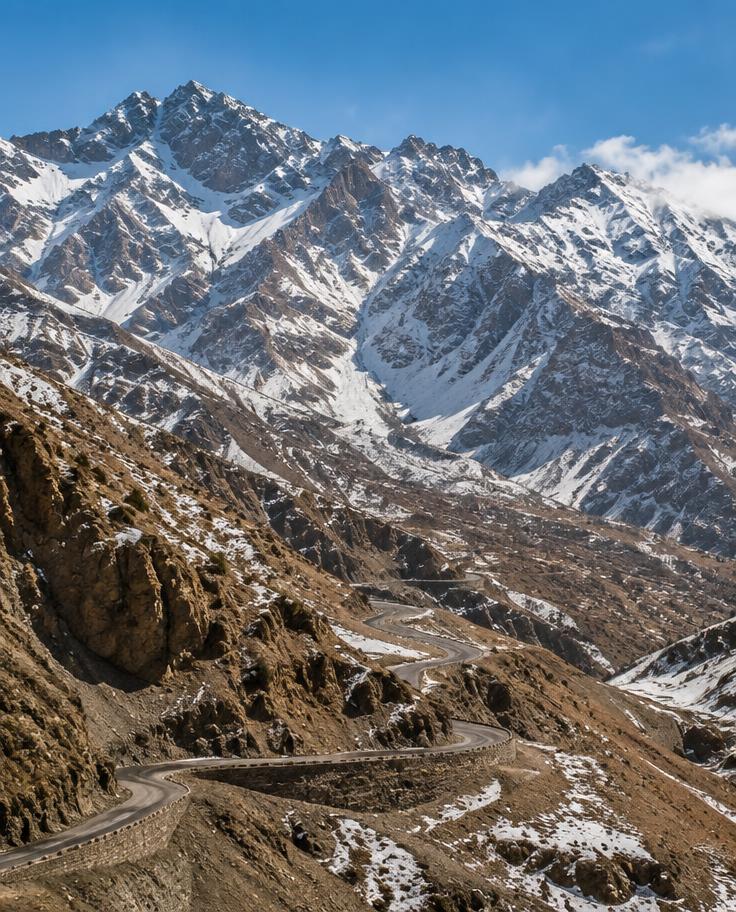 Snow-touched High Atlas peaks above a mountain pass road